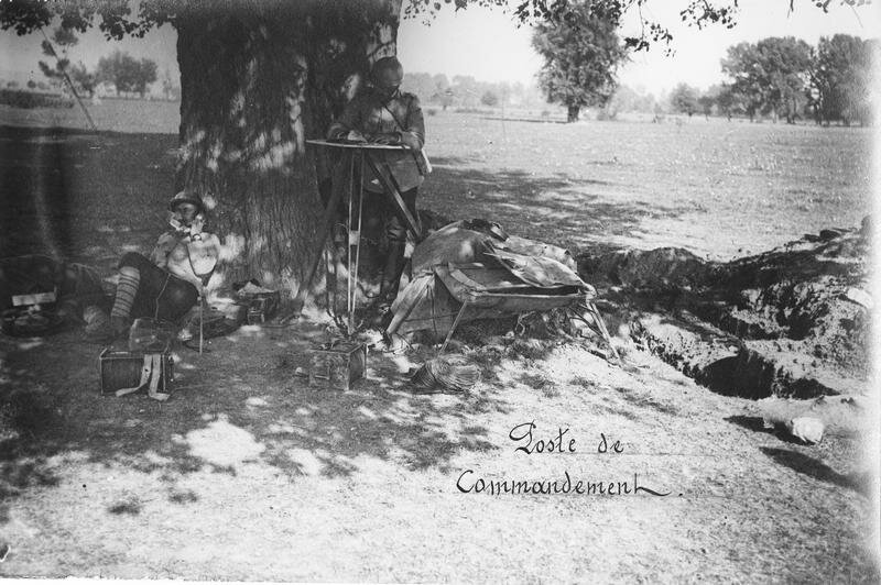 Command post under a tree, an operator and the commander left the following operations on a map