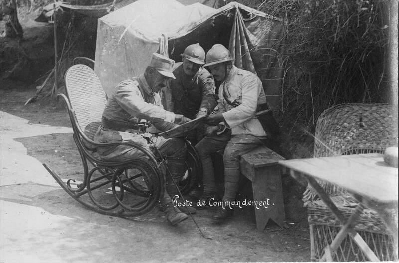 Infantry command post. tent, table, wicker chair and rocking chair, a group of officers studying the map