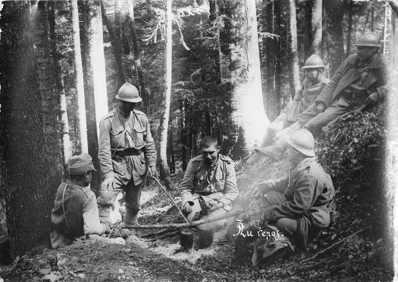 Soldiers at rest in a forest fire for heating the bowls