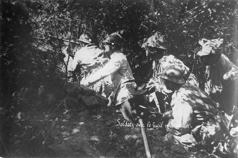 Soldiers in the forest with a machine gun