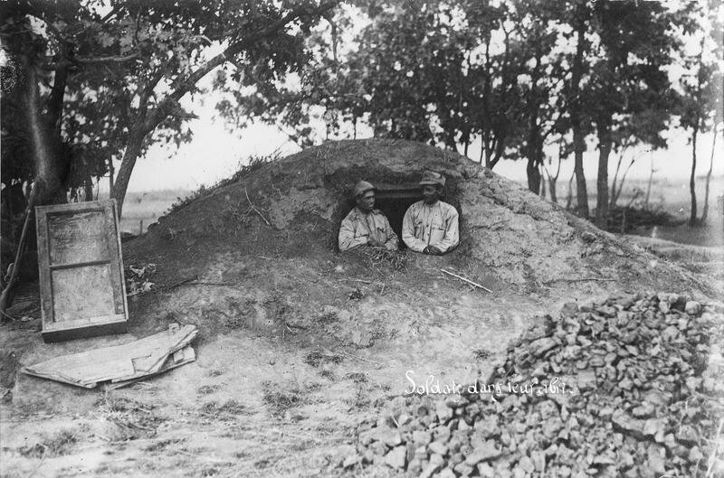 Two soldiers in their shelter, earth mound