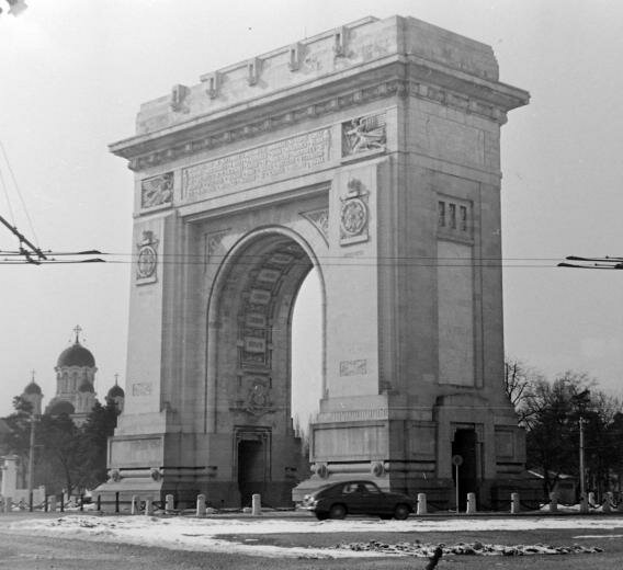 1958 Triumphal Arch (Arcul de Triumf), in the background the Casin Monastery (Orthodox Church).